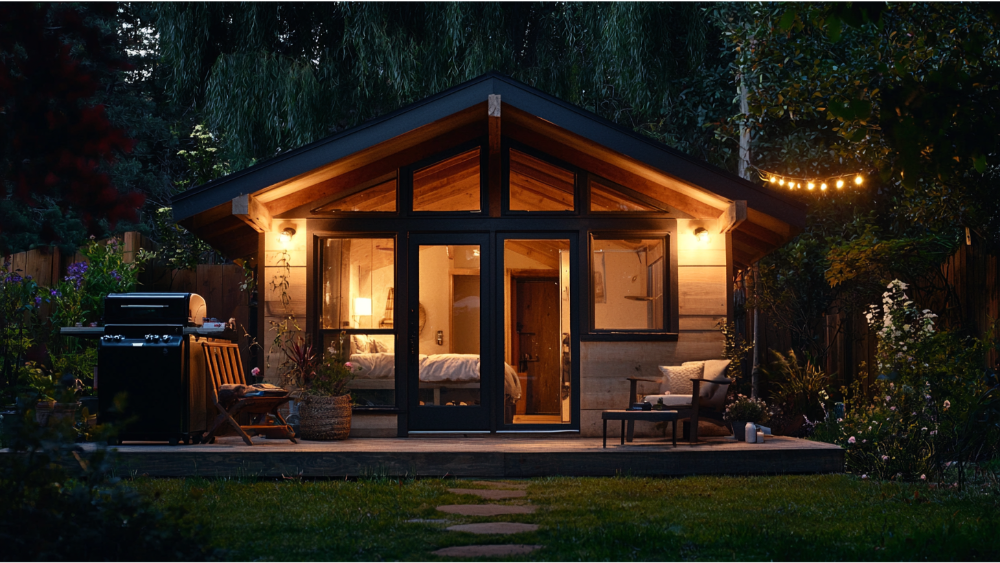 Small backyard guest house with warm lights and outdoor seating.